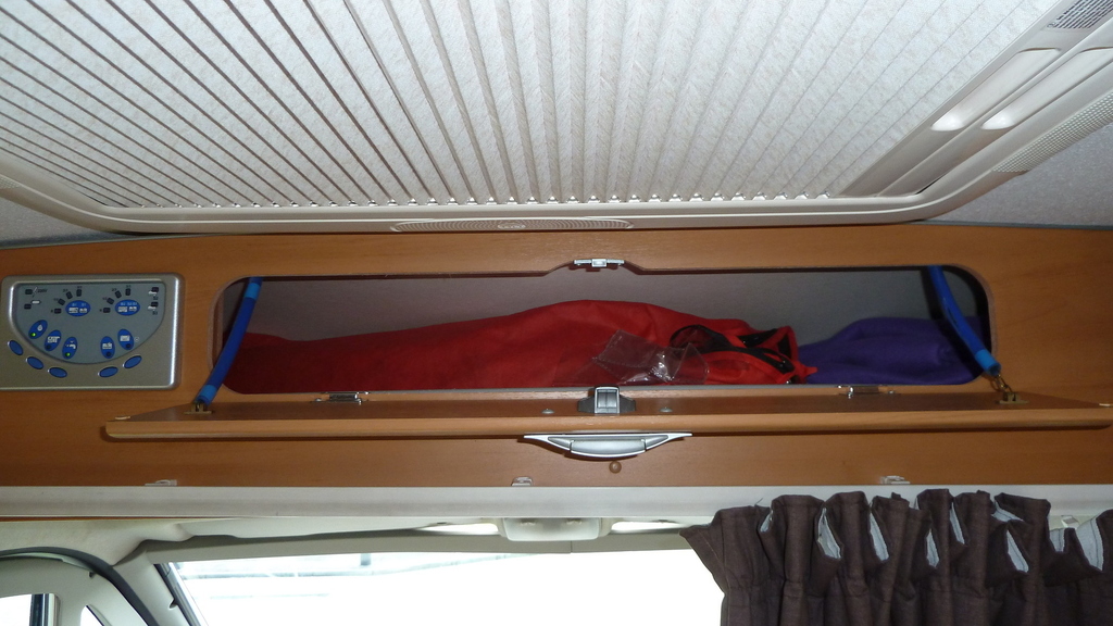Locker above cab. Will take folding camping chairs etc
