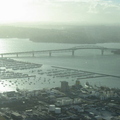 Aukland harbour bridge with the 'city of sails' in the forground.