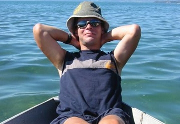 Me, trying to pose while in an old rowing boat that had a leak!