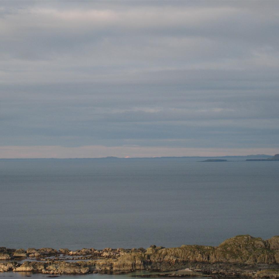 View out west over Tiree & Coll to Barra, Uist & Harris