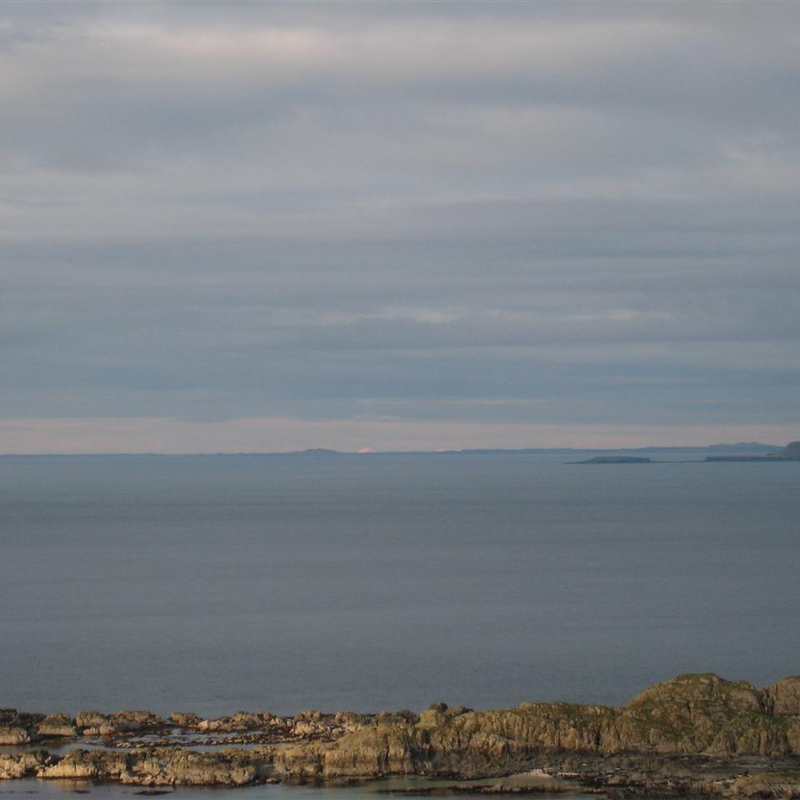 View out west over Tiree & Coll to Barra, Uist & Harris