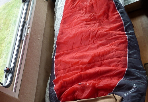 Near side single bed next to sliding door (uses cab seat)