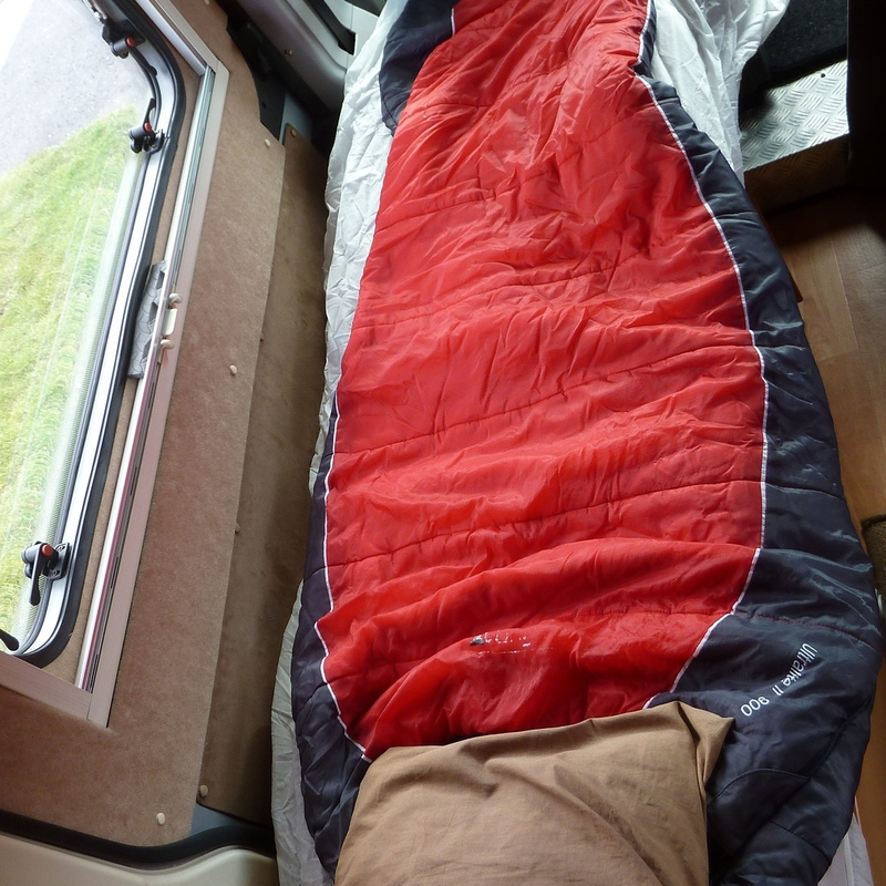 Near side single bed next to sliding door (uses cab seat)
