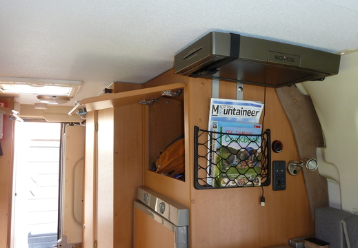 Cupboard and storage pocket above fridge
