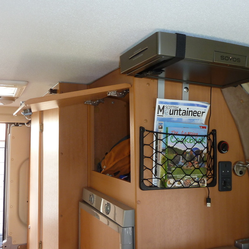 Cupboard and storage pocket above fridge